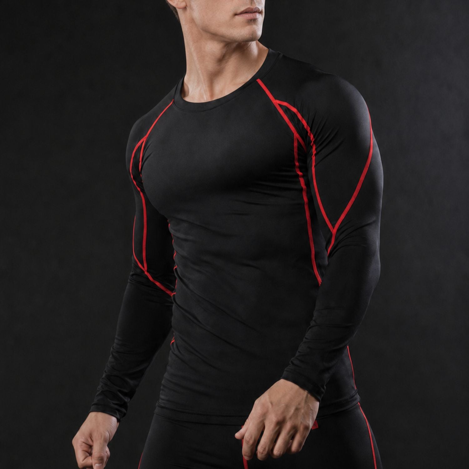 Men’s black compression workout shirt with long sleeves, athletic fit and bold red seam accents for gym training.