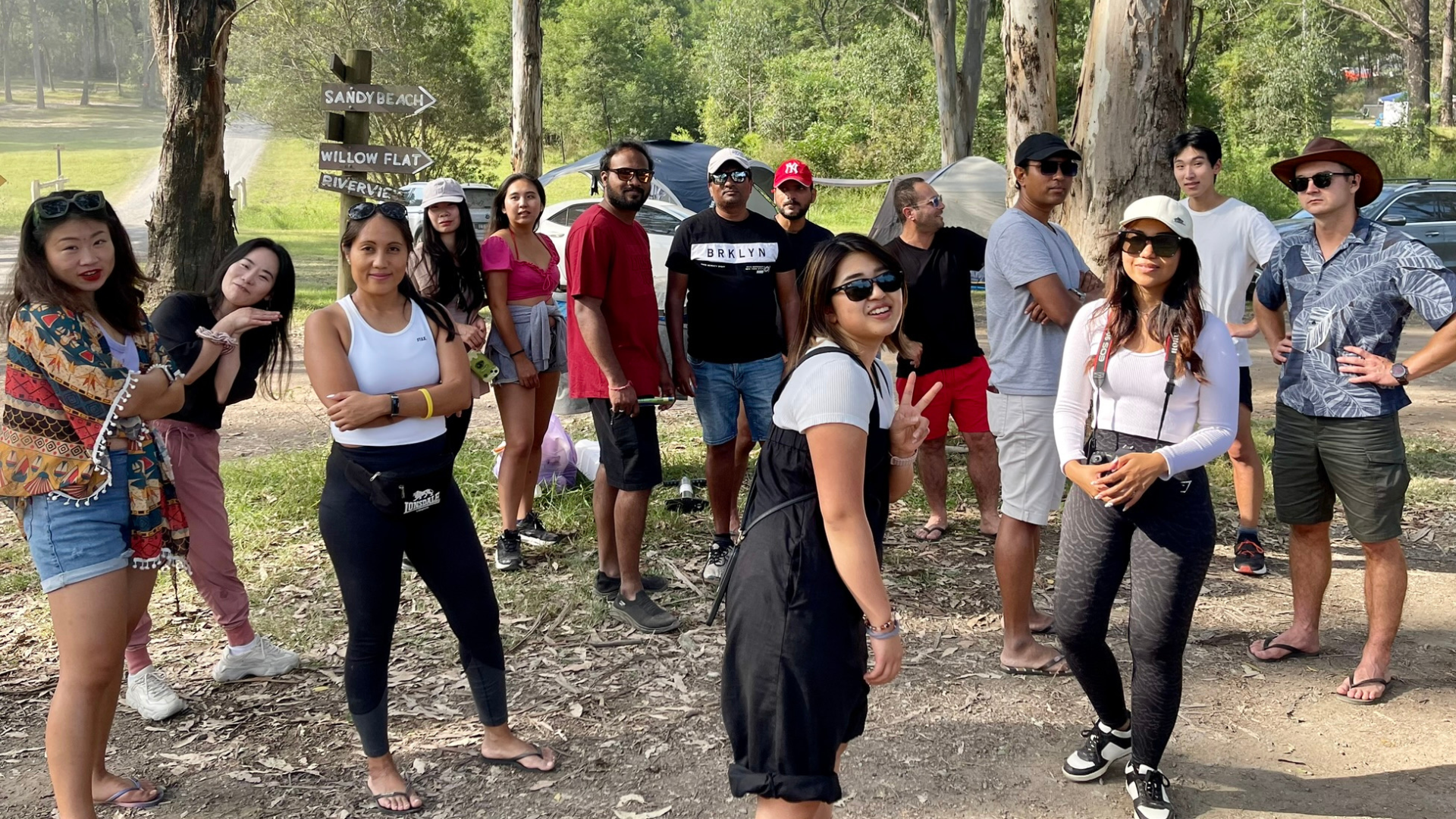 Group camping event in Sydney with campers setting up tents and enjoying the outdoors. Join a camping group for social camping adventures and shop tents for your next trip.